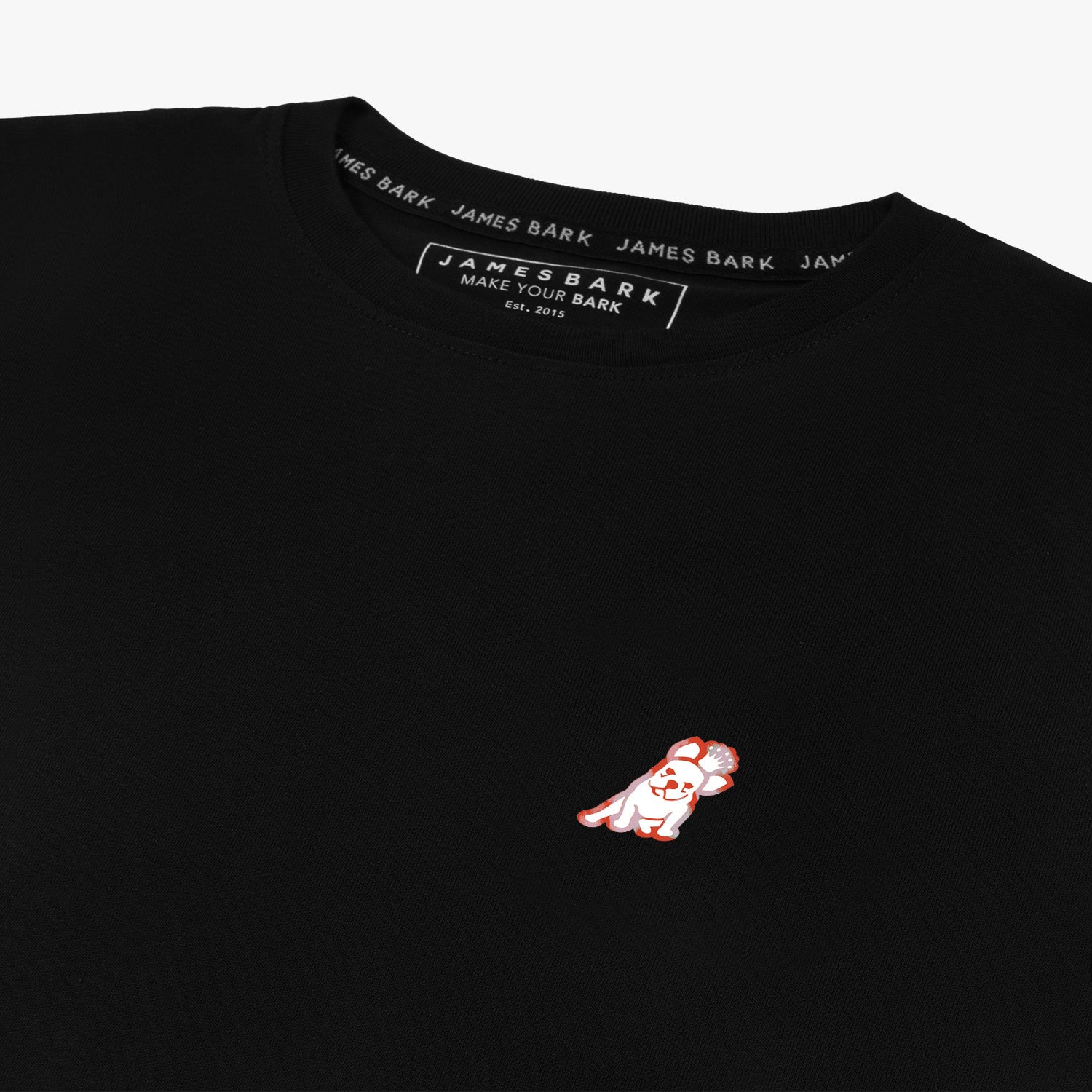 Close-up of the neckline of the black T-shirt, showing the label and detailed stitching.