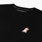 Close-up of the small embroidered logo on the front of the black t-shirt.