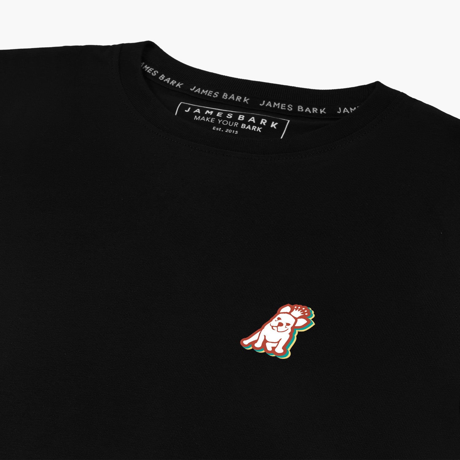 Close-up of the small embroidered logo on the front of the black t-shirt.