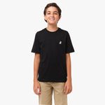 Front view of a young boy wearing a black T-shirt with a small decorative 'JB' logo on the chest, paired with beige pants.