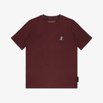 Flat-lay front view of the maroon t-shirt showing the small white embroidered logo on the chest.