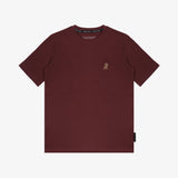 Flat-lay front view of the maroon t-shirt showing the small yellow embroidered logo on the chest.