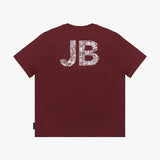 Flat-lay view of the maroon t-shirt showing the back with large "JB" lettering filled with a white design.