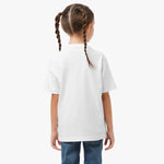 Back view of a young girl wearing a white t-shirt and jeans, showing the back of the shirt.