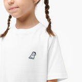 Close-up of the girl wearing the white T-shirt, focusing on the small dog graphic on the chest.