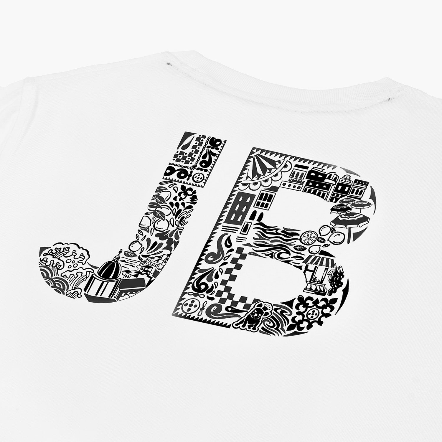 Close-up of the back of the white t-shirt, showing the "JB" lettering with a black pattern.