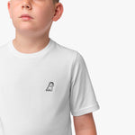 Close-up front view of a boy wearing the white t-shirt with a small embroidered logo on the chest.