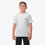 Front view of a boy standing and wearing a white t-shirt with a small logo on the chest.