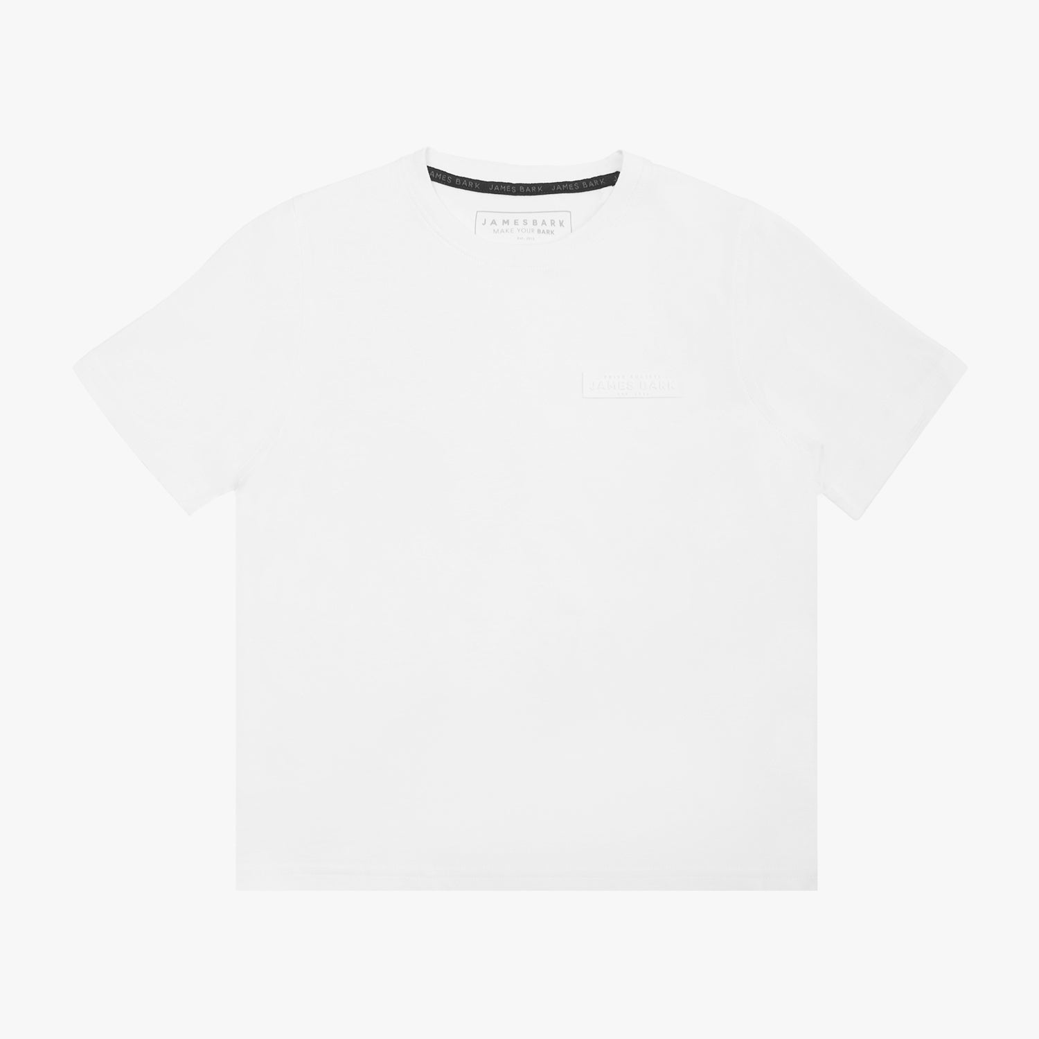 A white short-sleeved T-shirt featuring a subtle tonal logo patch on the upper left chest area that reads 'JAMES BARK.' The neckline includes a black inner lining with repeated 'JAMES BARK' branding, and the inside label also displays the brand name