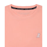 Close-up of the collar area of the light pink t-shirt, showing the small white embroidered logo on the chest.