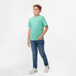 Full-body view of a boy wearing the mint green t-shirt and jeans, standing with one hand in his pocket.