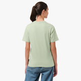 Back view of a woman wearing the light green T-shirt with blue jeans.