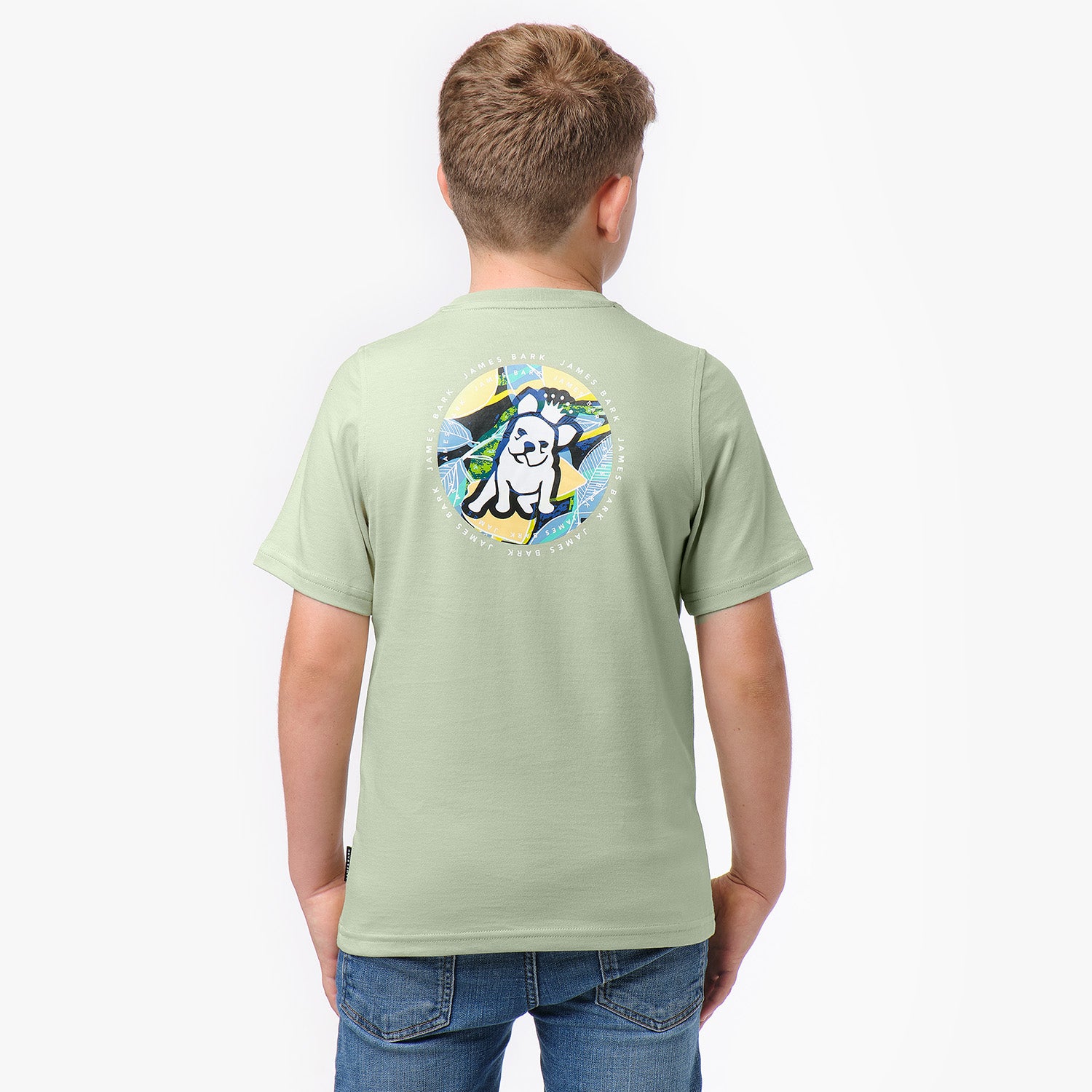 Back view of a light green T-shirt featuring a colorful graphic of a dog with sunglasses in a circular design on the back.