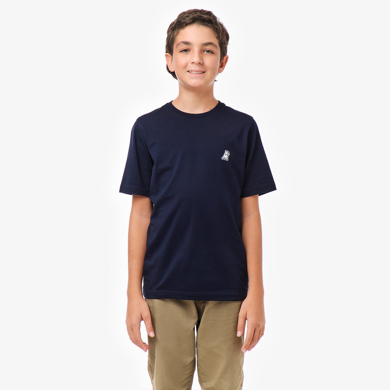 Front view of a boy wearing a navy blue T-shirt with a small dog graphic on the chest