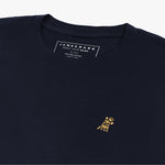 Close-up of the inner label and embroidered logo on the navy blue t-shirt: A detailed shot showing the inner neck label with branding and care information, as well as the small gold embroidered dog logo on the left chest.