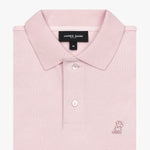 Folded pink polo shirt showing collar, buttons, brand tag, and light pink embroidered dog logo