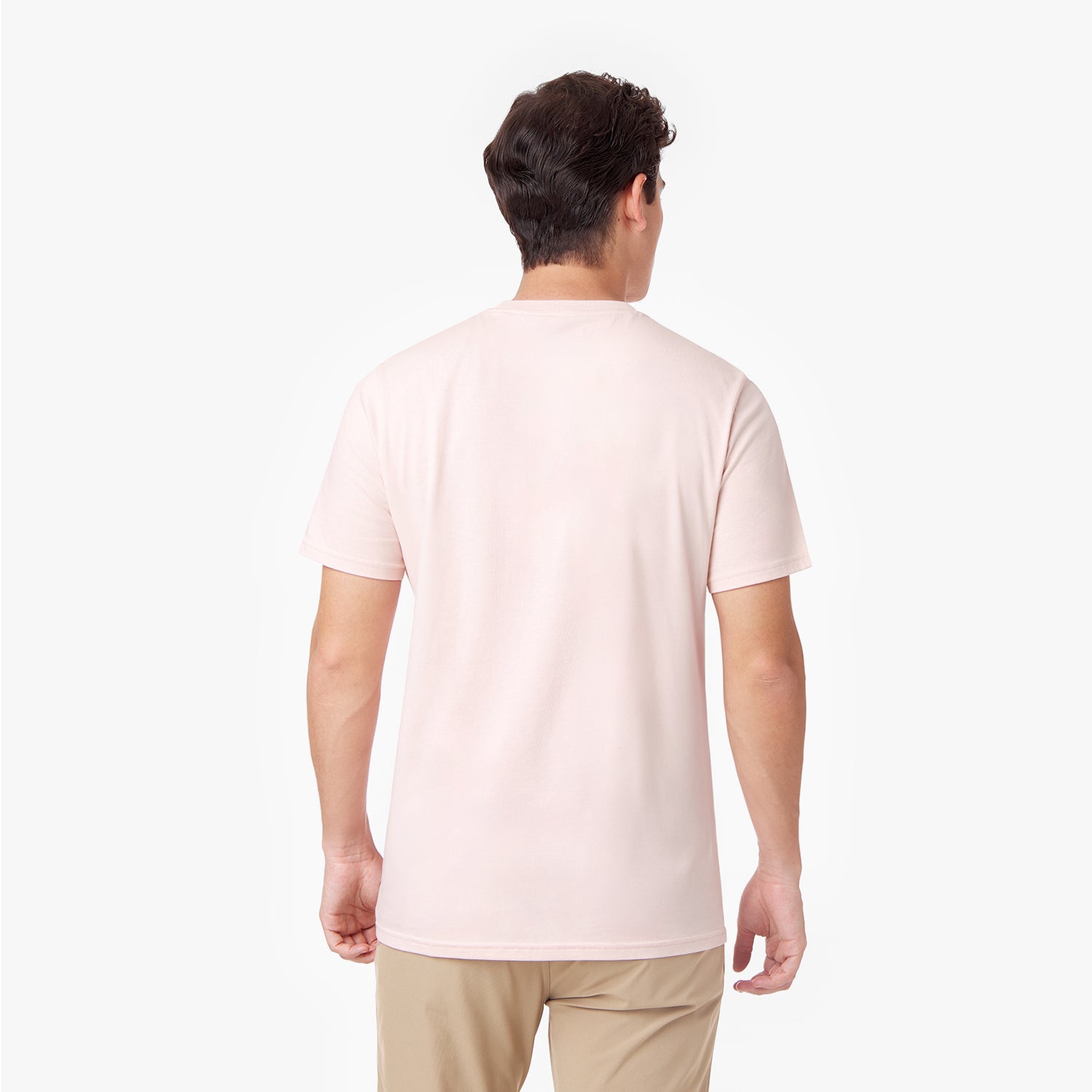 Rear view of a male model wearing the pink crew neck t-shirt, showcasing its clean and minimal back design