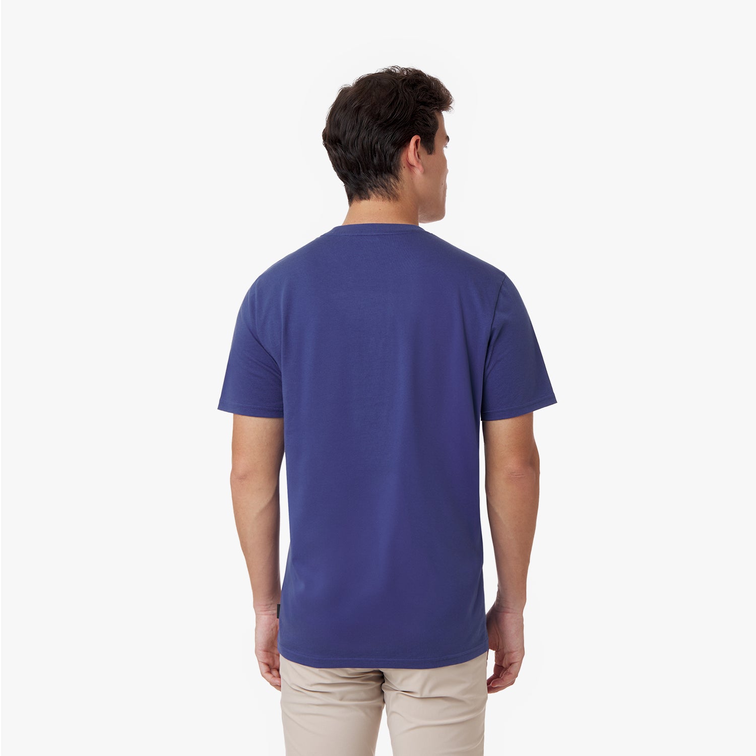 Back view of the male model wearing the navy blue James Bark crew neck t-shirt, showcasing the solid back design