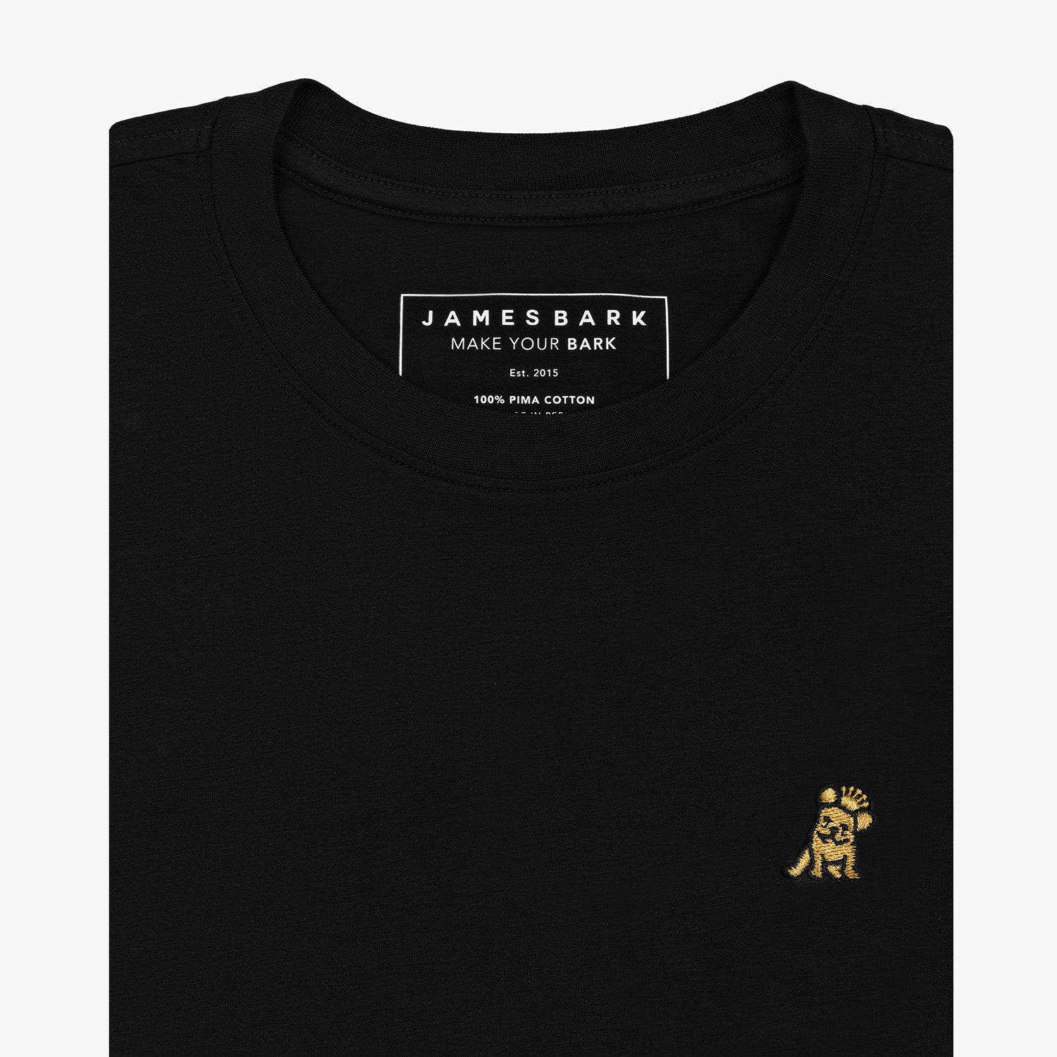 Close-up of the chest area of the black t-shirt: A detailed view of the small embroidered dog logo in gold on the left chest, contrasting against the black fabric.