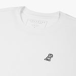 Close-up of the inner label and embroidered logo on the white t-shirt: A detailed shot showing the inner neck label with branding and care information, as well as the small black embroidered dog logo on the left chest.