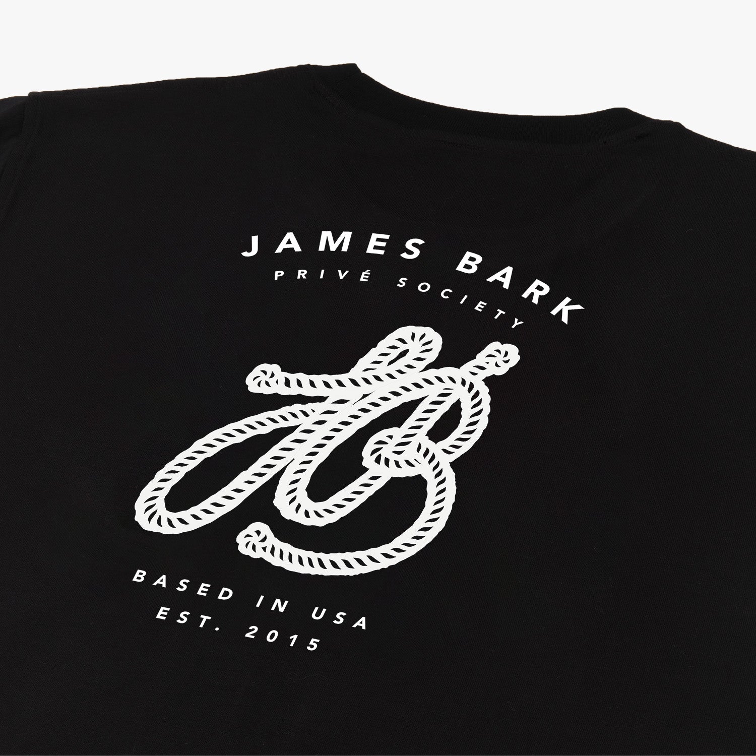 Close-up of the large graphic on the back of the black t-shirt, featuring the text 'James Bark,' a stylized 'JB' logo, and 'Since 2015.