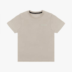 A beige short-sleeved T-shirt featuring a subtle tonal logo patch on the upper left chest area that reads 'JAMES BARK.' The neckline includes a black inner lining with repeated 'JAMES BARK' branding, and the inside label also displays the brand name