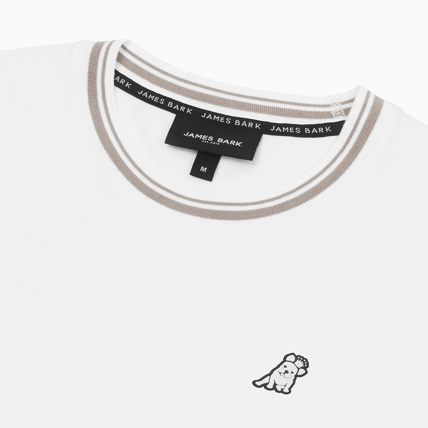 Close-up view of the t-shirt's beige-trimmed collar and embroidered animal logo on the left chest.