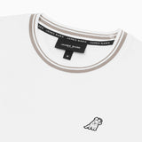 Close-up view of the t-shirt's beige-trimmed collar and embroidered animal logo on the left chest.