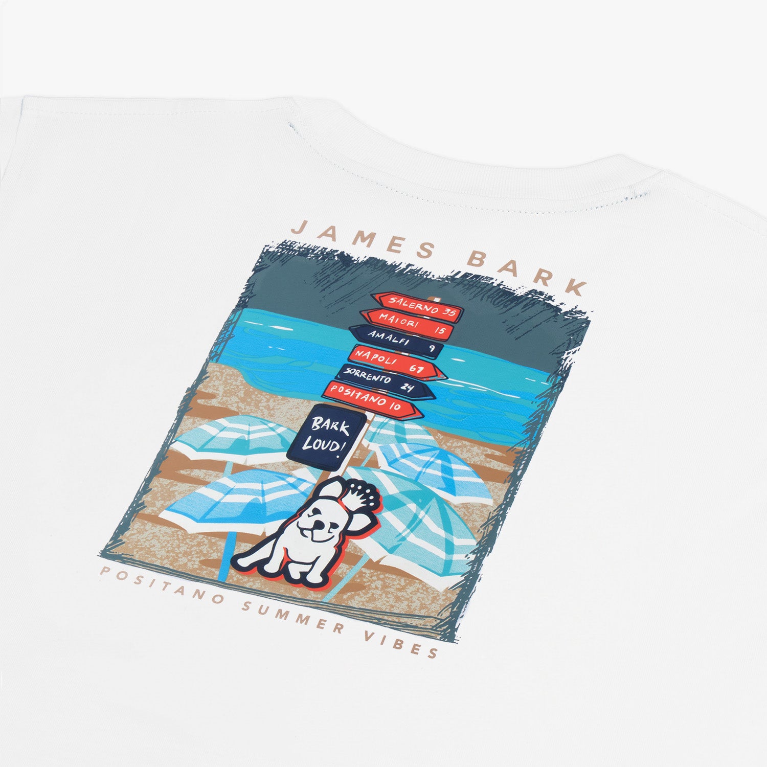 Close-up of a white t-shirt back print featuring a colorful beach scene with a French bulldog. The design shows beach umbrellas and a signpost with destinations like Salerno, Maiori, Amalfi, Napoli, Sorrento, and Positano. The bulldog holds a sign that says 'Bark Loud!' The top text reads 'James Bark,' and below the image, it says 'Positano Summer Vibes.