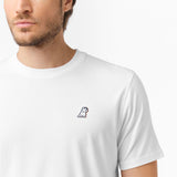 Close-up of the white t-shirt's left chest, showing a small logo design.