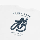 Close-up of the large graphic on the back of the white t-shirt, featuring the text 'James Bark,' a stylized 'JB' logo, and 'Since 2015.