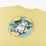 A close-up of the back design on the yellow T-shirt, showing the large circular graphic with the dog and tropical background, along with "James Bark Privé Society" text around the circle.