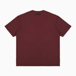 Back view of a plain maroon T-shirt displayed flat, featuring a small black rectangular label positioned near the neckline. The T-shirt is showcased on a plain white background." Let me know if you’d like to adjust this description