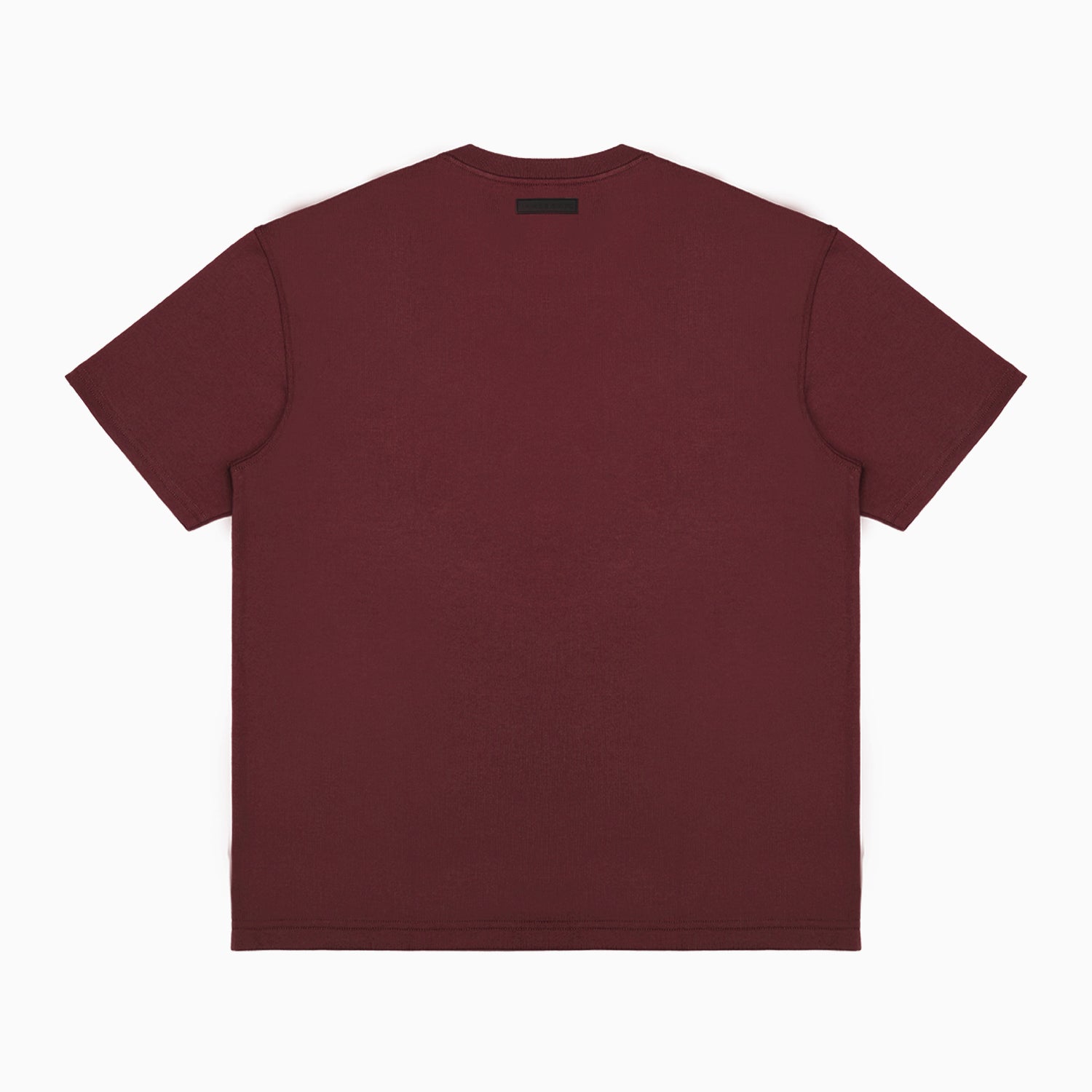 Back view of a plain maroon T-shirt displayed flat, featuring a small black rectangular label positioned near the neckline. The T-shirt is showcased on a plain white background." Let me know if you’d like to adjust this description