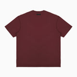 Back view of a plain maroon T-shirt displayed flat, featuring a small black rectangular label positioned near the neckline. The T-shirt is showcased on a plain white background." Let me know if you’d like to adjust this description