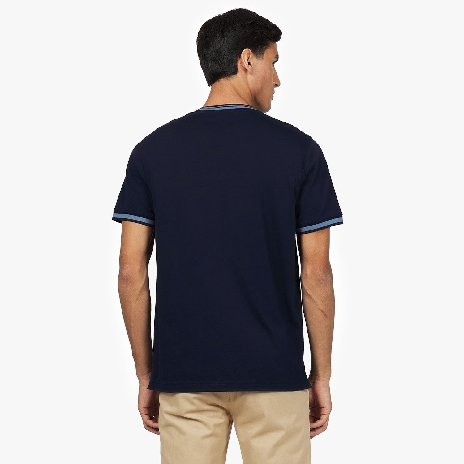 Back view of a man wearing the navy blue T-shirt with light blue trim on the collar and sleeves.