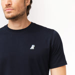 Close-up of the navy blue t-shirt's left chest, showing a small logo design.