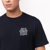 Close-up of the navy blue t-shirt's left chest, showing the white graphic design