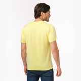 Back view of a man wearing a yellow t-shirt, showing the plain back.