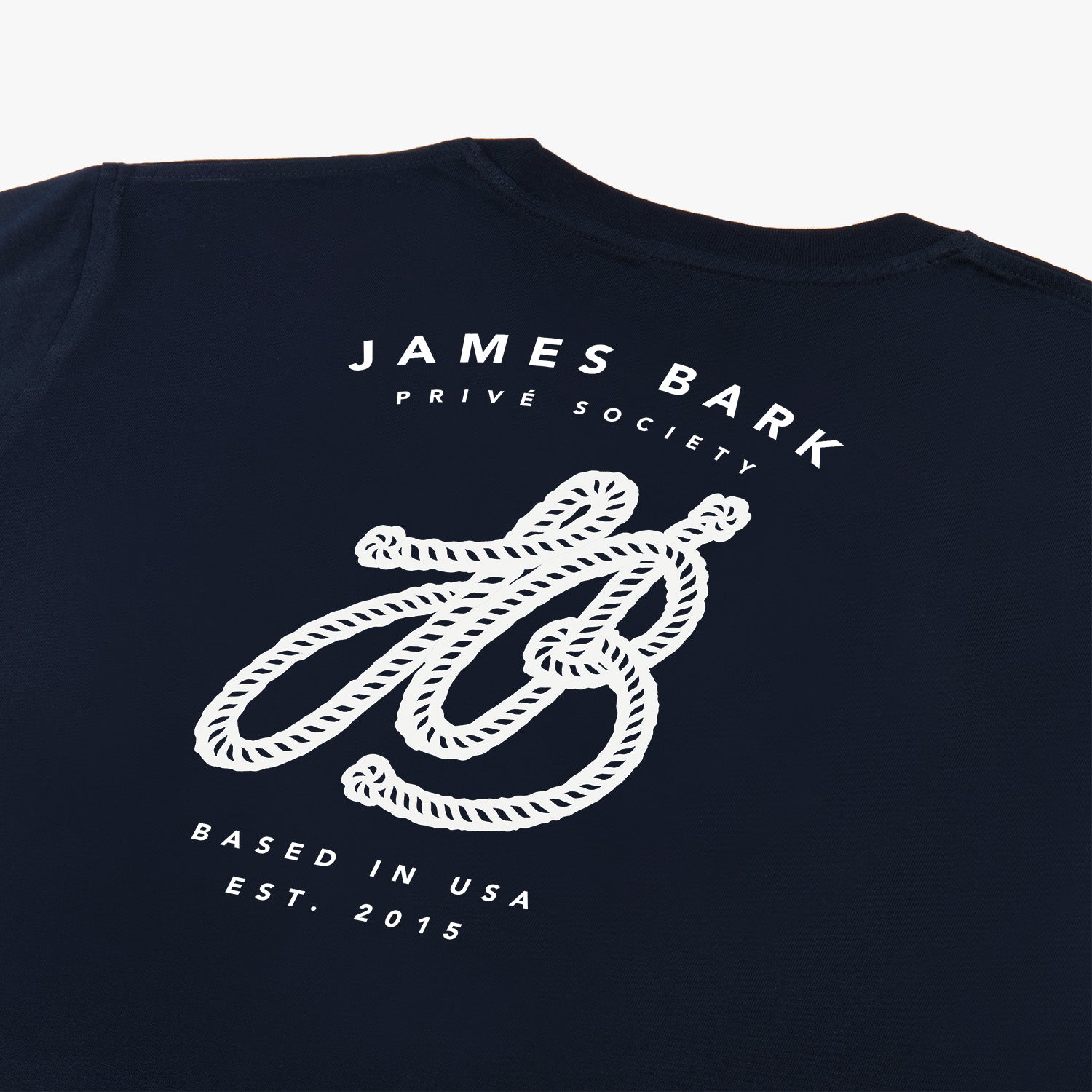 Close-up of the large graphic on the back of the navy blue t-shirt, featuring the text 'James Bark,' a stylized 'JB' logo, and 'Since 2015.