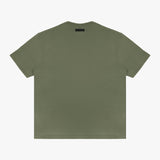 Full-body shot of the model wearing the olive green t-shirt, standing casually with one hand in his pocket.