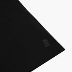 Zoomed-in shot of the black t-shirt’s fabric, focusing on the subtle logo embroidered onto the sleeve.