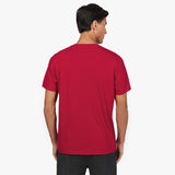 Back view of a man wearing the plain red T-shirt with dark pants.