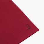 Zoomed-in shot of the  t-shirt’s fabric, focusing on the subtle logo embroidered onto the sleeve.