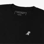 Close-up of the inner label and embroidered logo on the black t-shirt: A detailed shot showing the inner neck label with branding and care information, as well as the small white embroidered dog logo on the left chest.