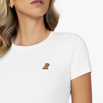 Close-up detail of the white crew neck t-shirt worn by a model, showing the fabric texture and the small gold embroidered dog logo on the left chest