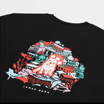 Close-up of the back of the black t-shirt showing the detailed colorful graphic of buildings and a dog.