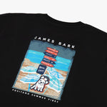 Close-up rear view of the t-shirt, focusing on the detailed beach scene with "James Bark" branding.