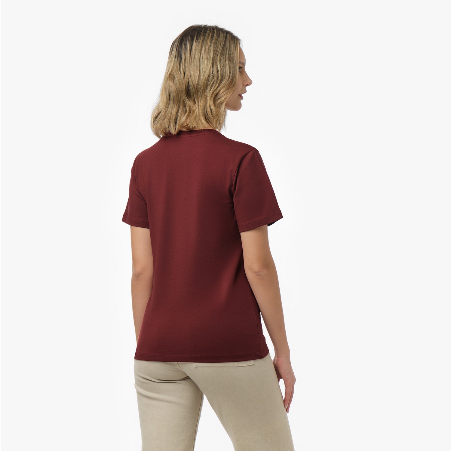 Back view of a woman wearing a plain maroon t-shirt and beige wide-leg pants