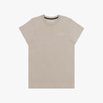 A beige short-sleeved T-shirt featuring a subtle tonal logo patch on the upper left chest area that reads 'JAMES BARK.' The neckline includes a black inner lining with repeated 'JAMES BARK' branding, and the inside label also displays the brand name